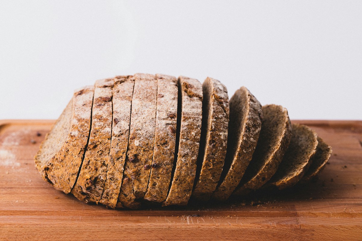 Sliced rustic loaf on a wooden bread board